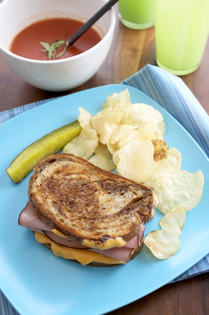Grilled Ham and Cheese Sandwich with Chips and a Pickle, Bowl of Soup