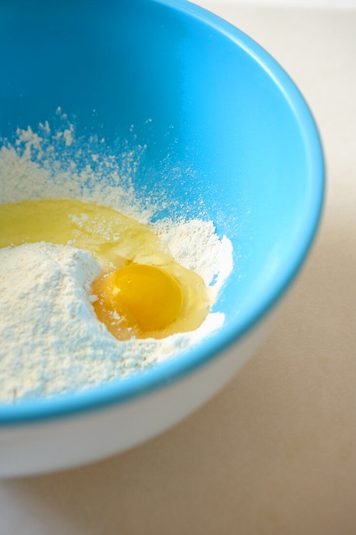 Cracked Egg in a Bowl of Flour