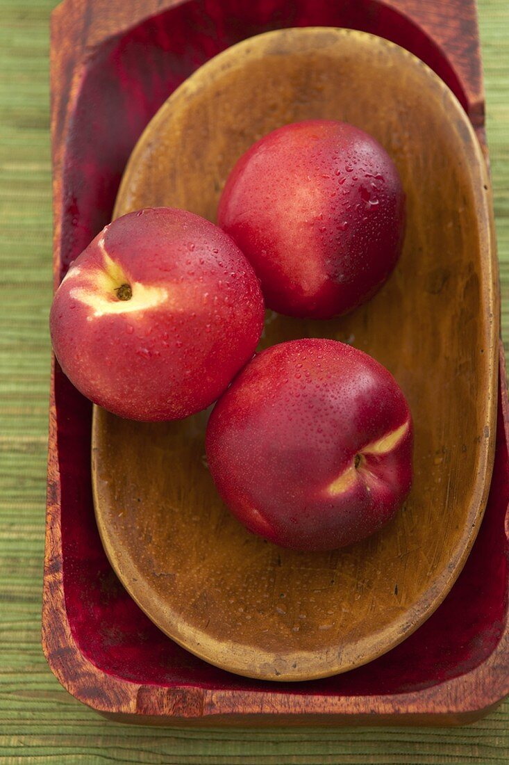 Three Nectarines in a Wooden Bowl