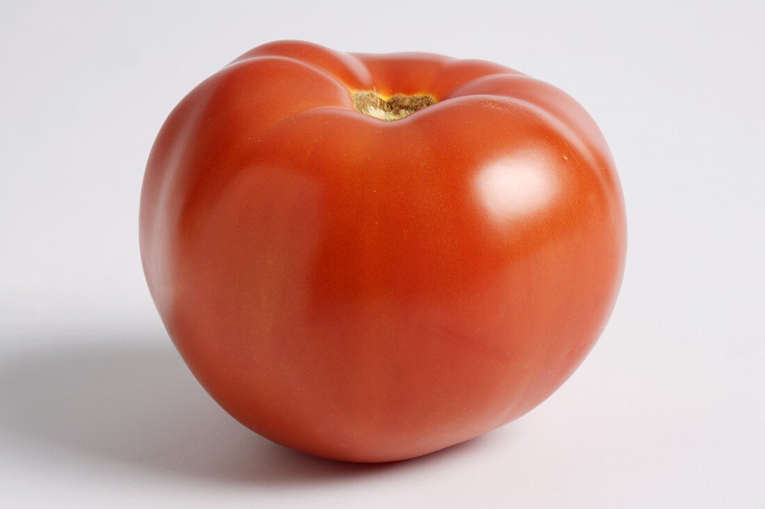 Whole Red Tomato on a White Background