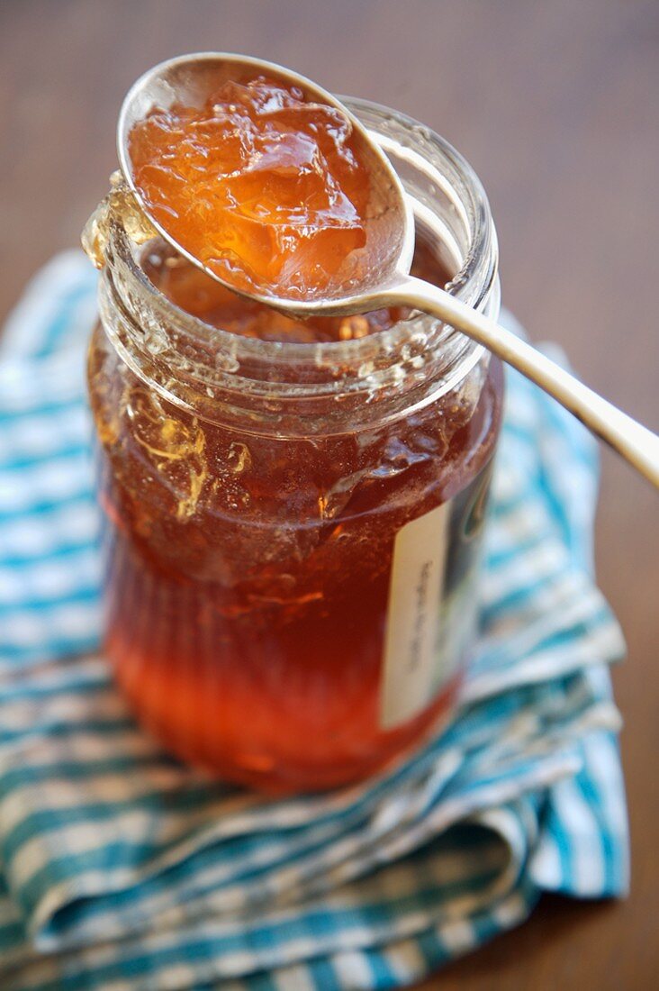 Weissdorngelee im Glas mit Löffel darauf