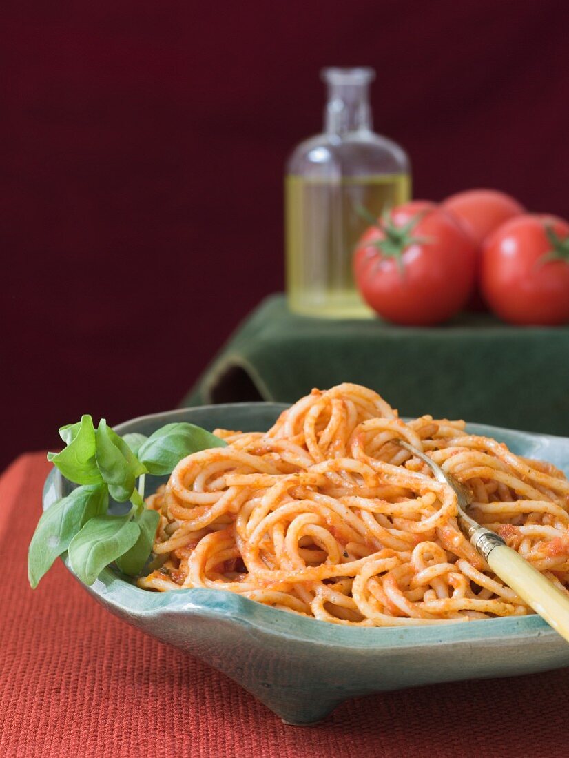 Bowl of Spaghetti Tossed in Tomato Sauce; Fork