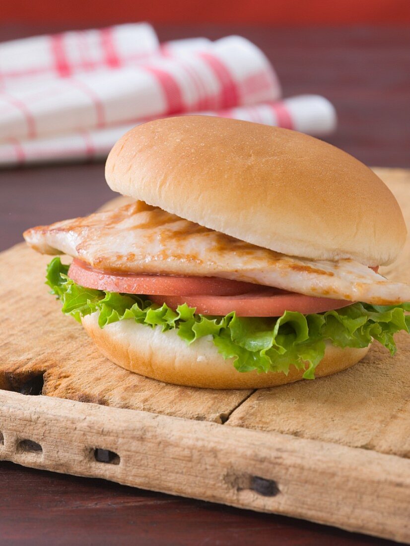 Grilled Chicken Sandwich with Lettuce and Tomato on a Bun