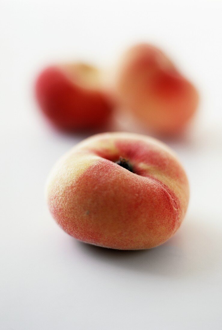 Flat Peaches on a White Background