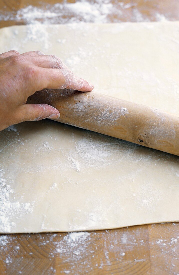 Rolling Out Pastry Dough with Wooden Rolling Pin