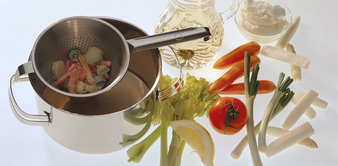 Vegetable stew ingredients; strainer with vegetables over pan