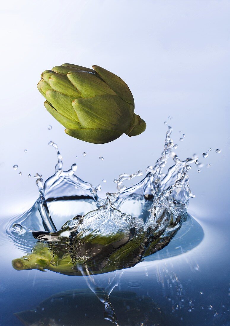 Artichokes falling into water