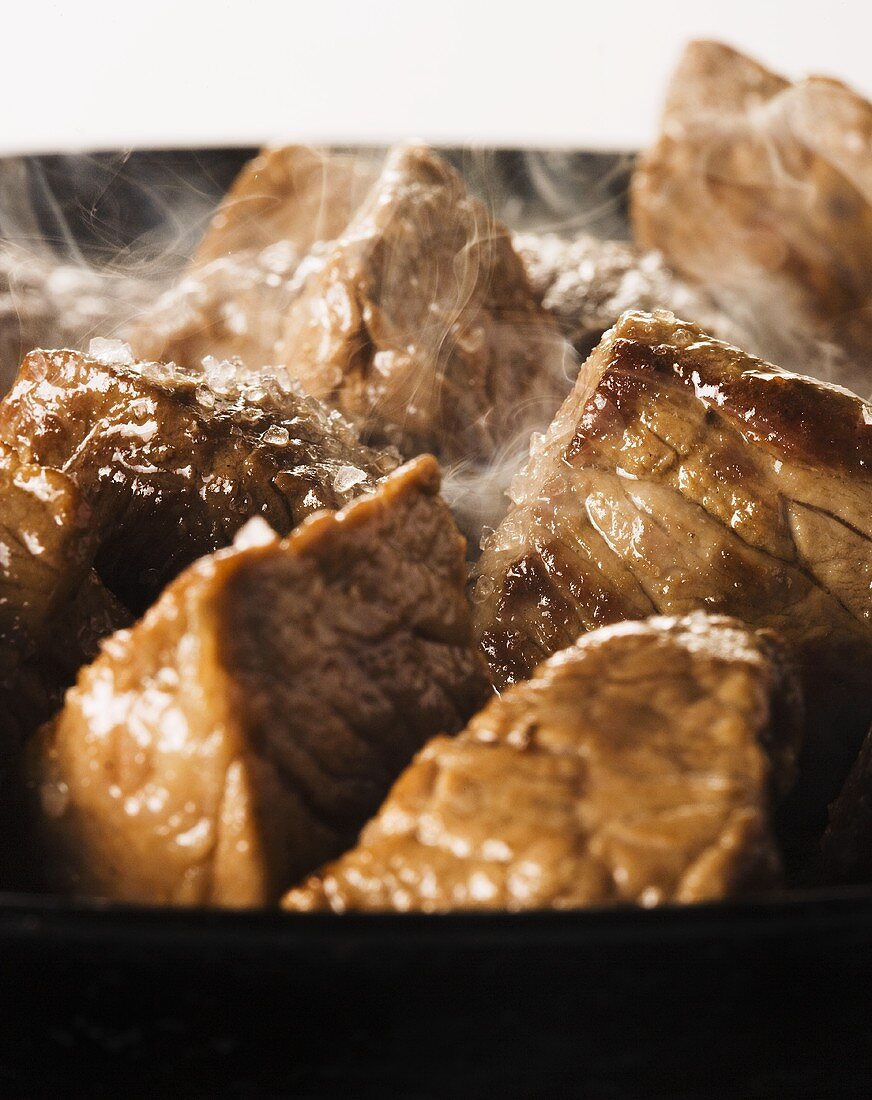 Beef being fried in a pan (close up)