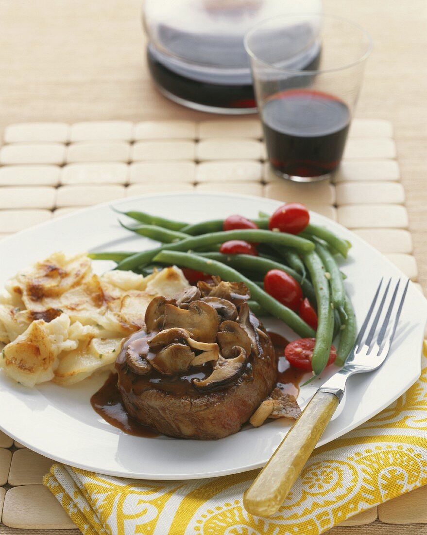 Steak with mushroom sauce, potatoes, green beans and tomatoes