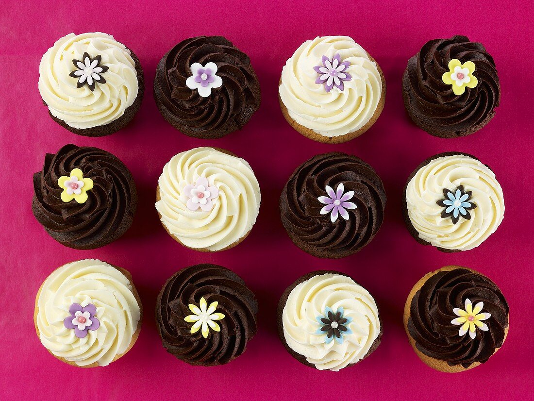 Cupcakes decorated with sugar flowers, seen from above