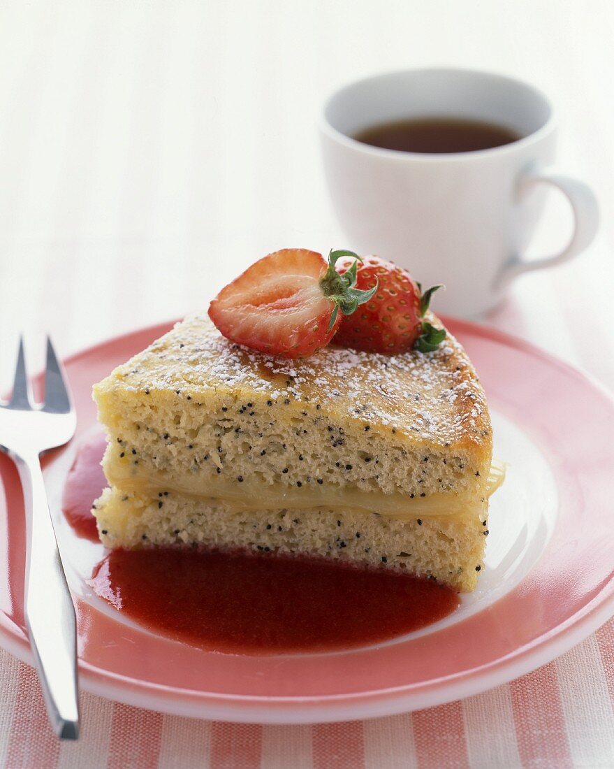 A piece of poppy seed cake with fresh strawberries