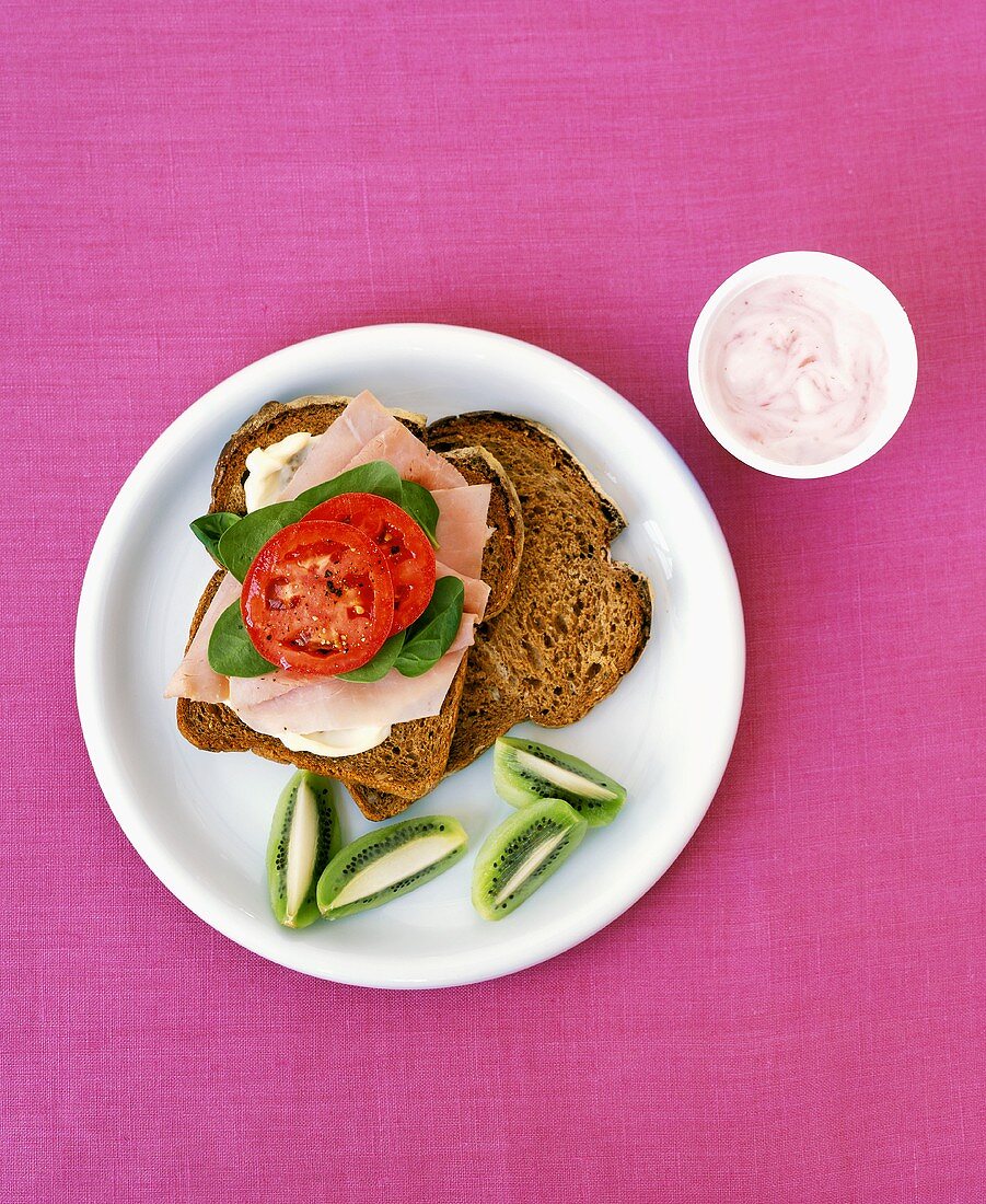 Ham on Whole Grain Bread with Lettuce and Tomato; Yogurt and Kiwi