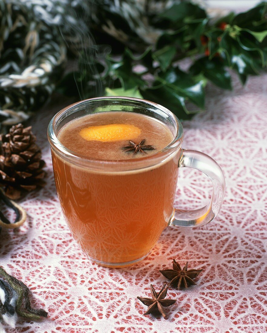 Steaming Cider in Glass Mug with Orange Zest and Star Anise