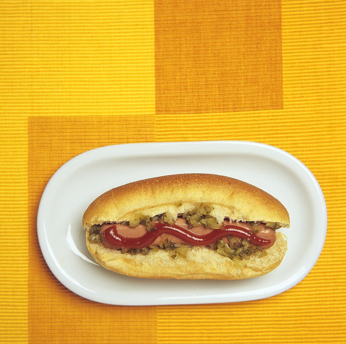 Hot dog with relish and ketchup (overhead view)