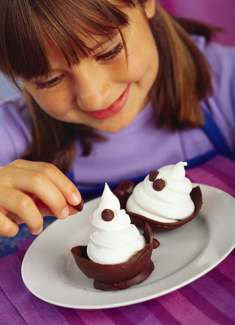 Girl decorating soft ice cream in chocolate shell