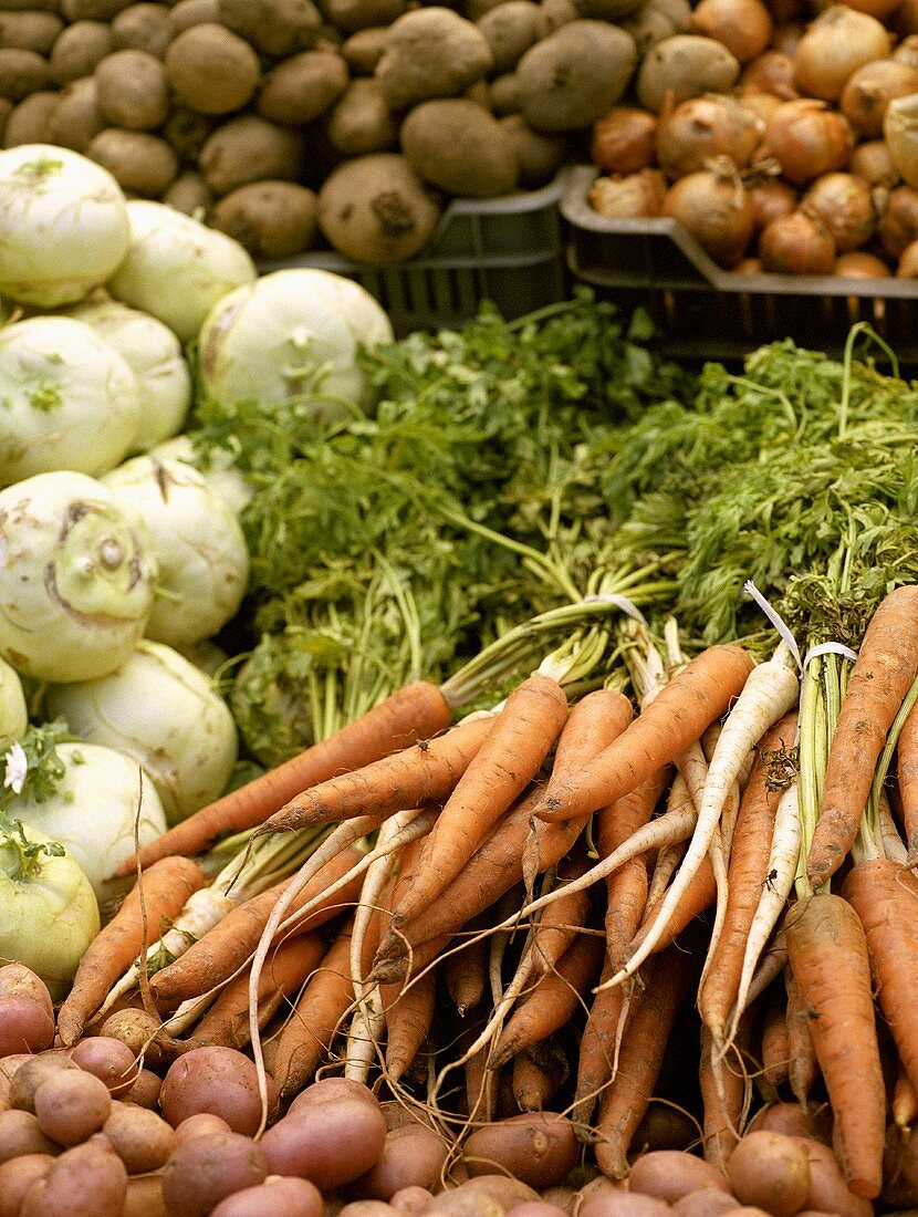 Vegetables at a market: carrots, potatoes, onions, kohlrabi
