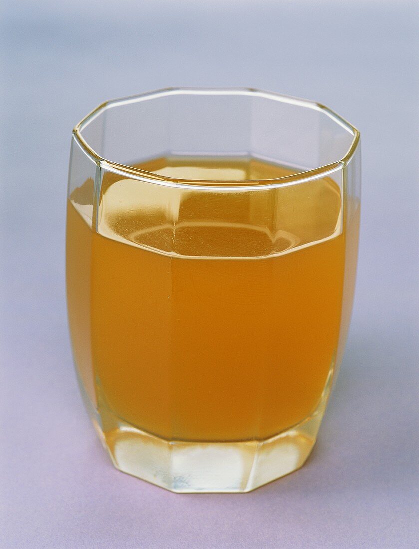 A glass of naturally cloudy apple juice