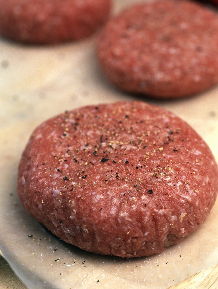 Raw rissoles with freshly ground pepper