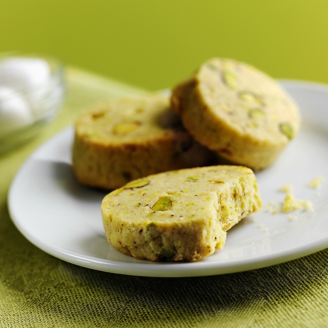 Pistachio biscuits on white plate