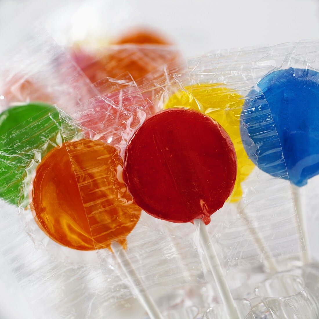 Coloured lollipops in cellophane wrappers
