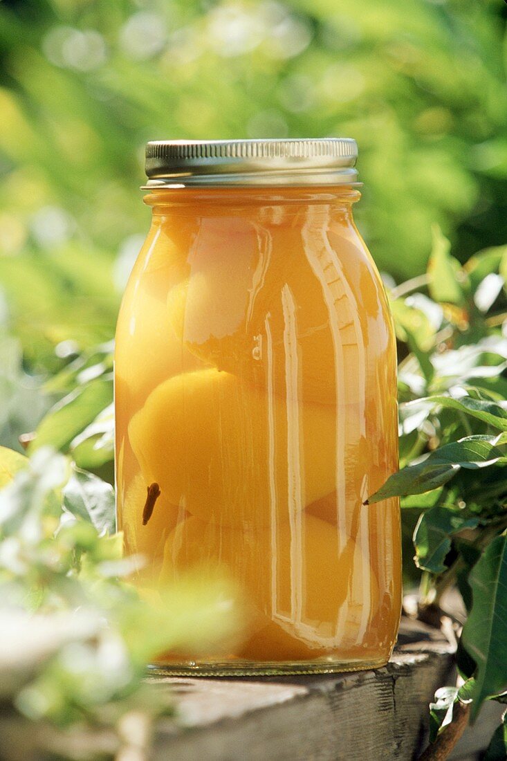 Pickled peaches in screw-top jar