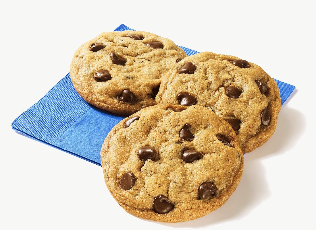 Drei Chocolate Chip Cookies auf blauer Serviette