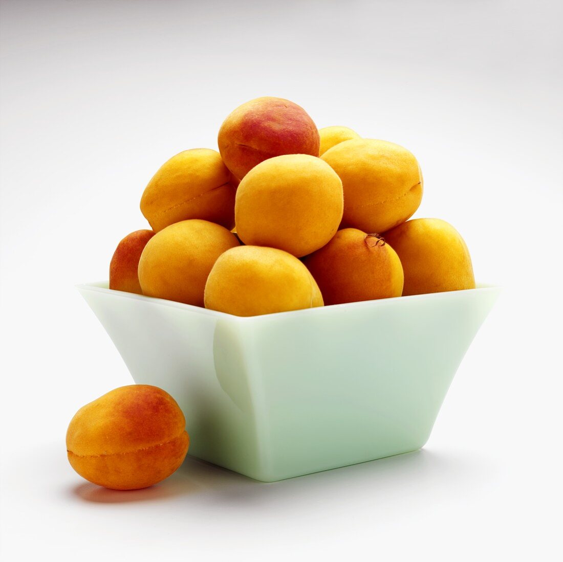 Fresh apricots in square bowl