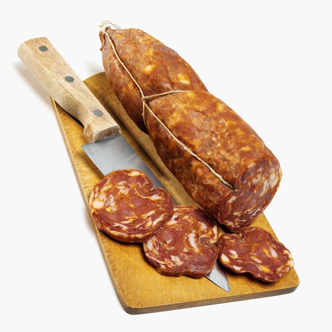 Sopressata with slices cut on chopping board
