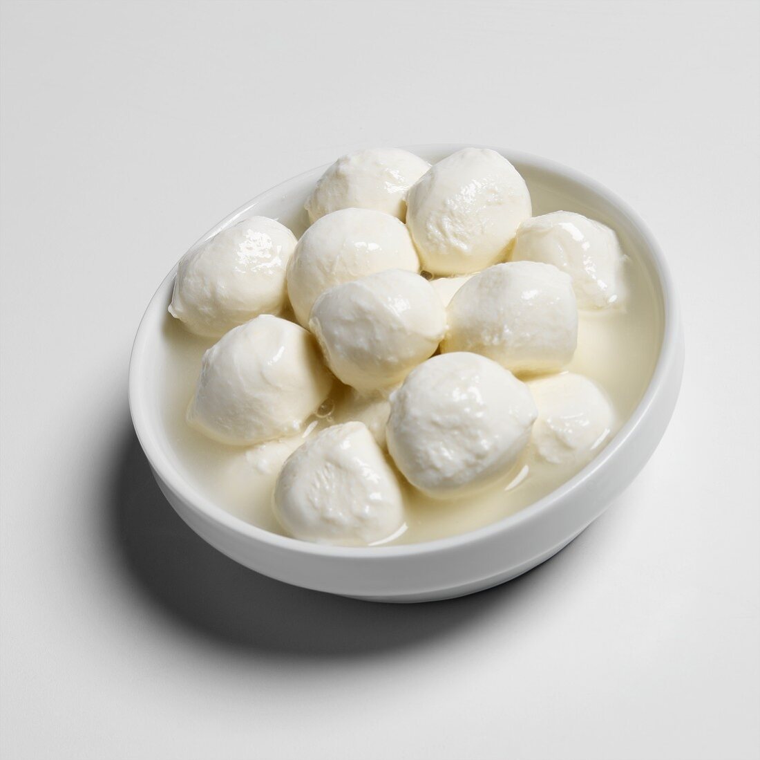 Mozzarella balls in white bowl