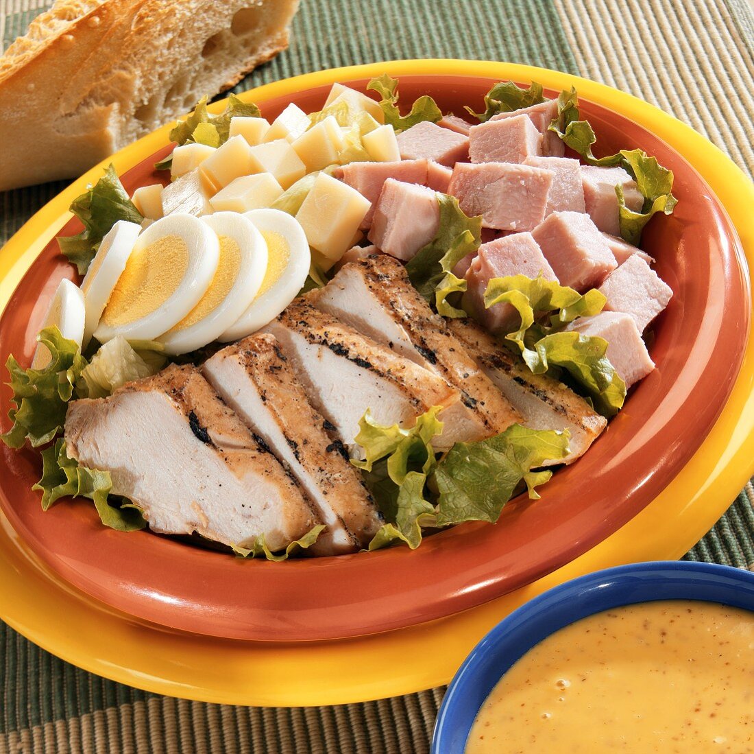 Chef salad with chicken, ham, egg & cheese; mustard dressing