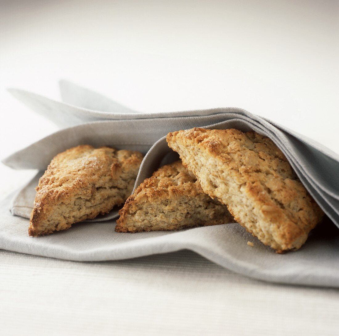 Three Oat Scones Wrapped in Linen