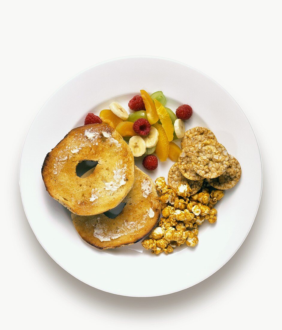 A Toasted Bagel with Fruit and Rice Cakes