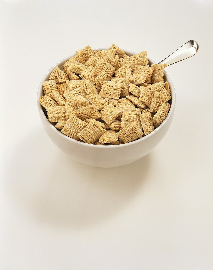 Wheat Cereal in a White Bowl with a Spoon