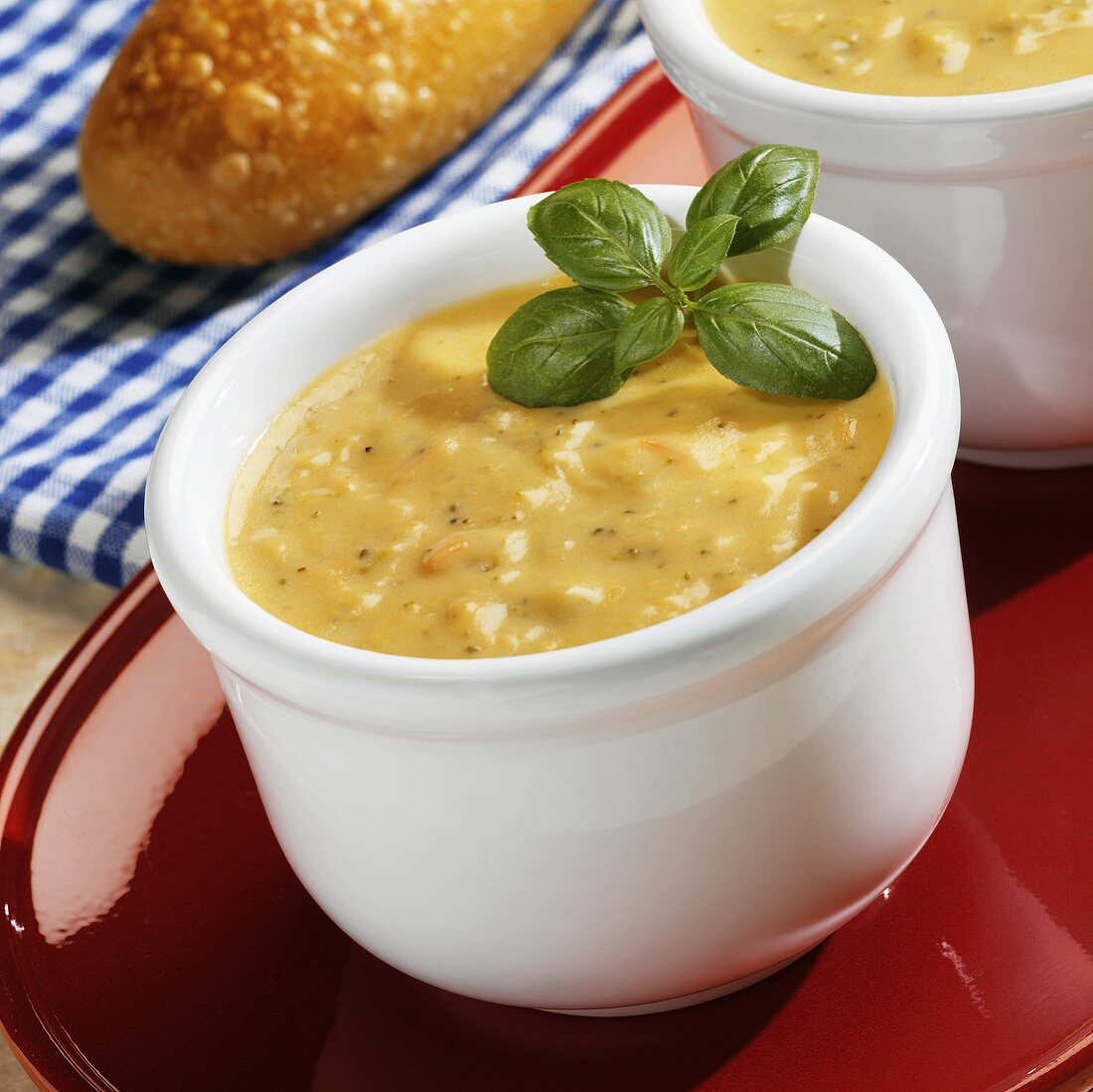 Cheddar Cheese Soup with Basil in a White Bowl