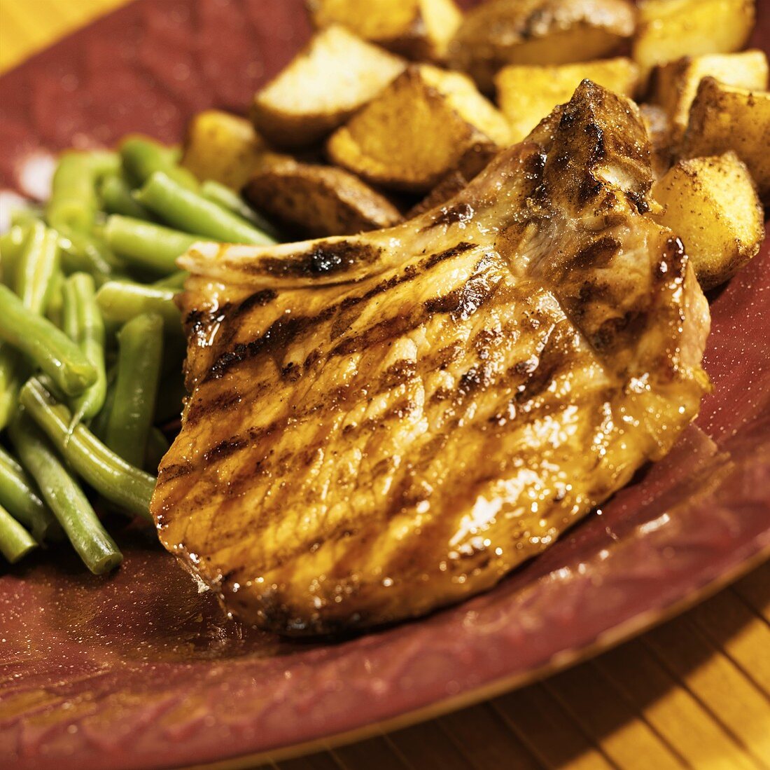 A Grilled Pork Chop with Honey-Maple Glaze, Green Beans and Potatoes