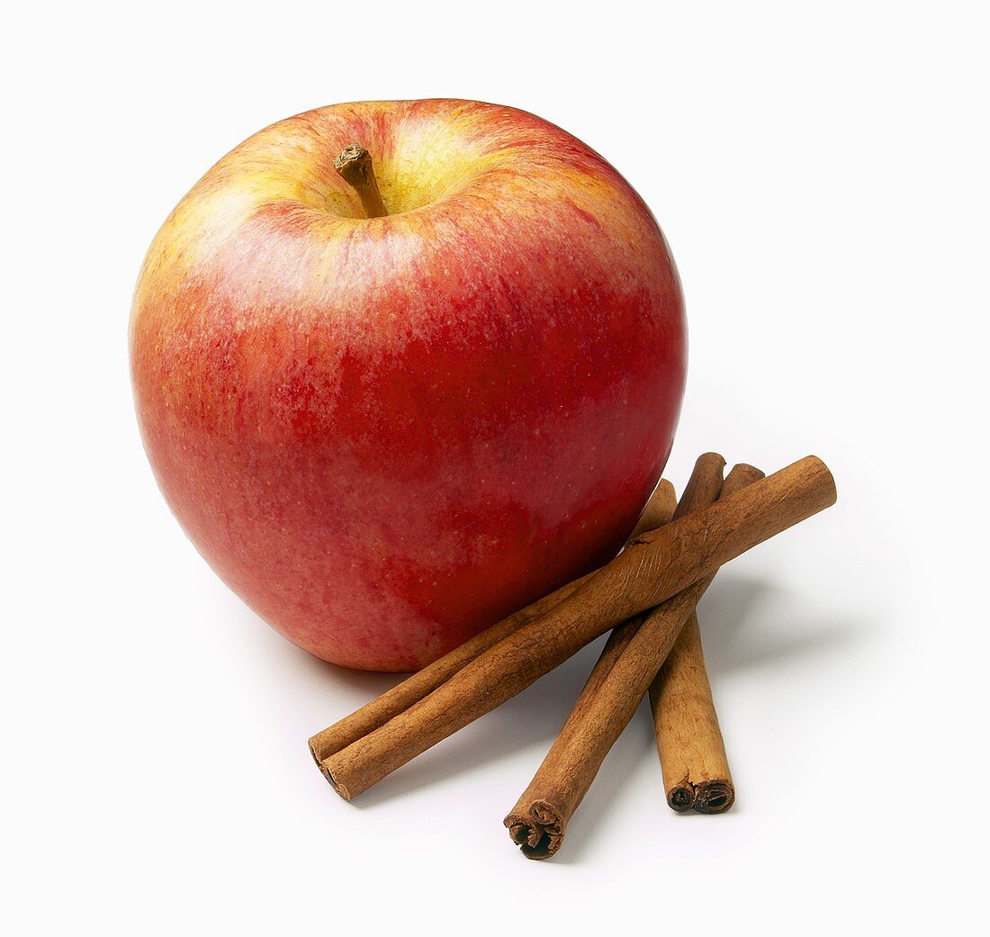 An Apple with Three Cinnamon Sticks