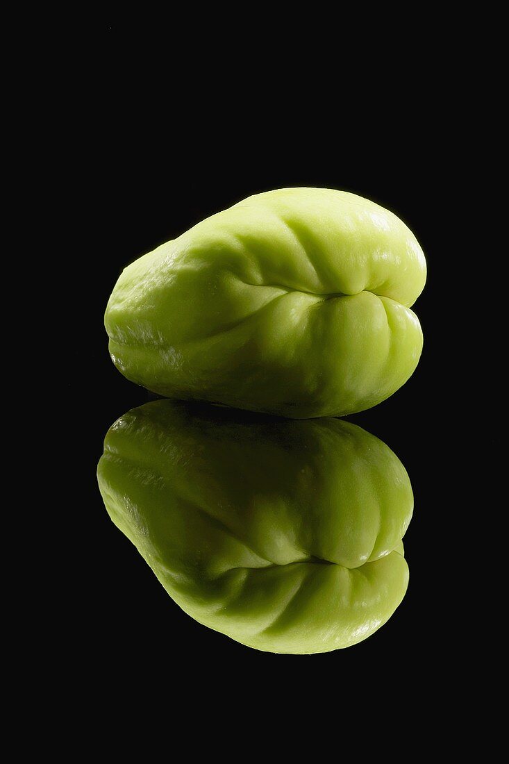 A Chayote Squash on Black with Reflection