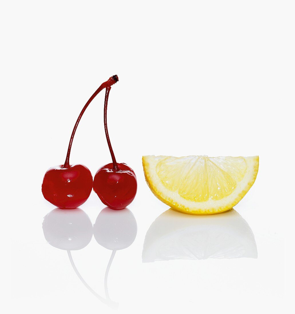 Two Maraschino Cherries with a Lemon Wedge
