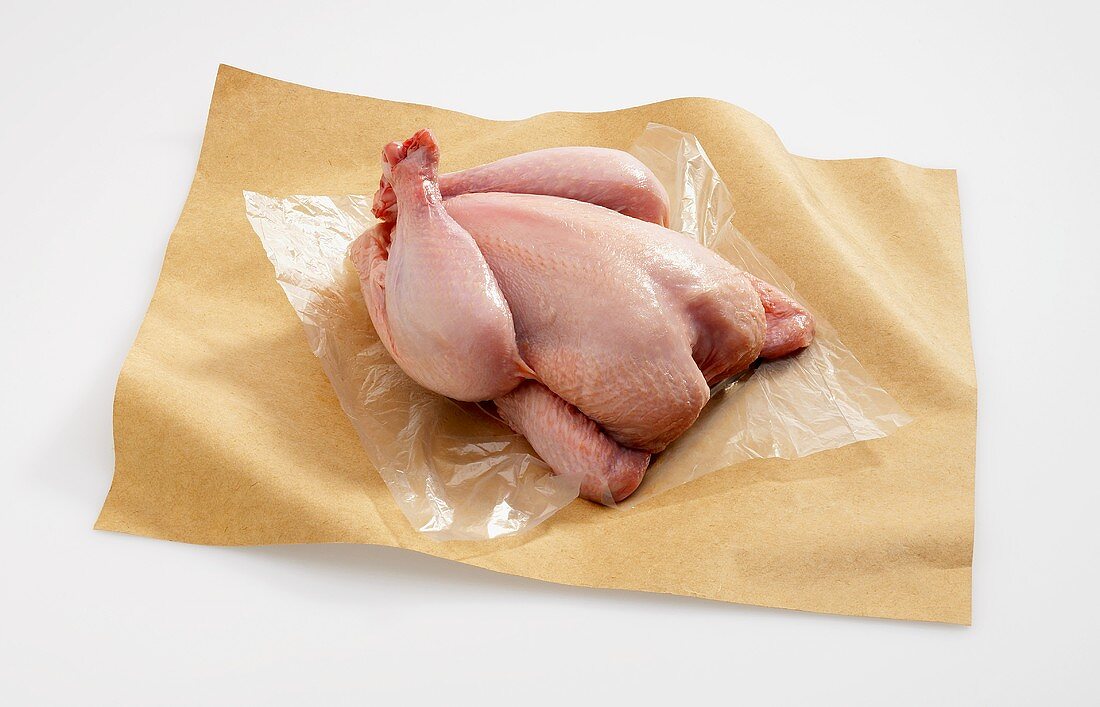 An Uncooked Cornish Game Hen on Butcher's Paper