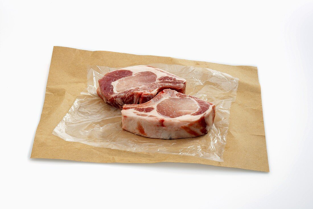 Two Raw Pork Chops on Butcher's Paper