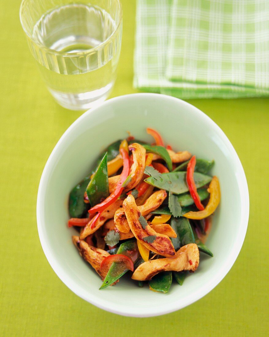 Chicken, Snow Pea and Bell Pepper Stir Fry with a Glass of Water