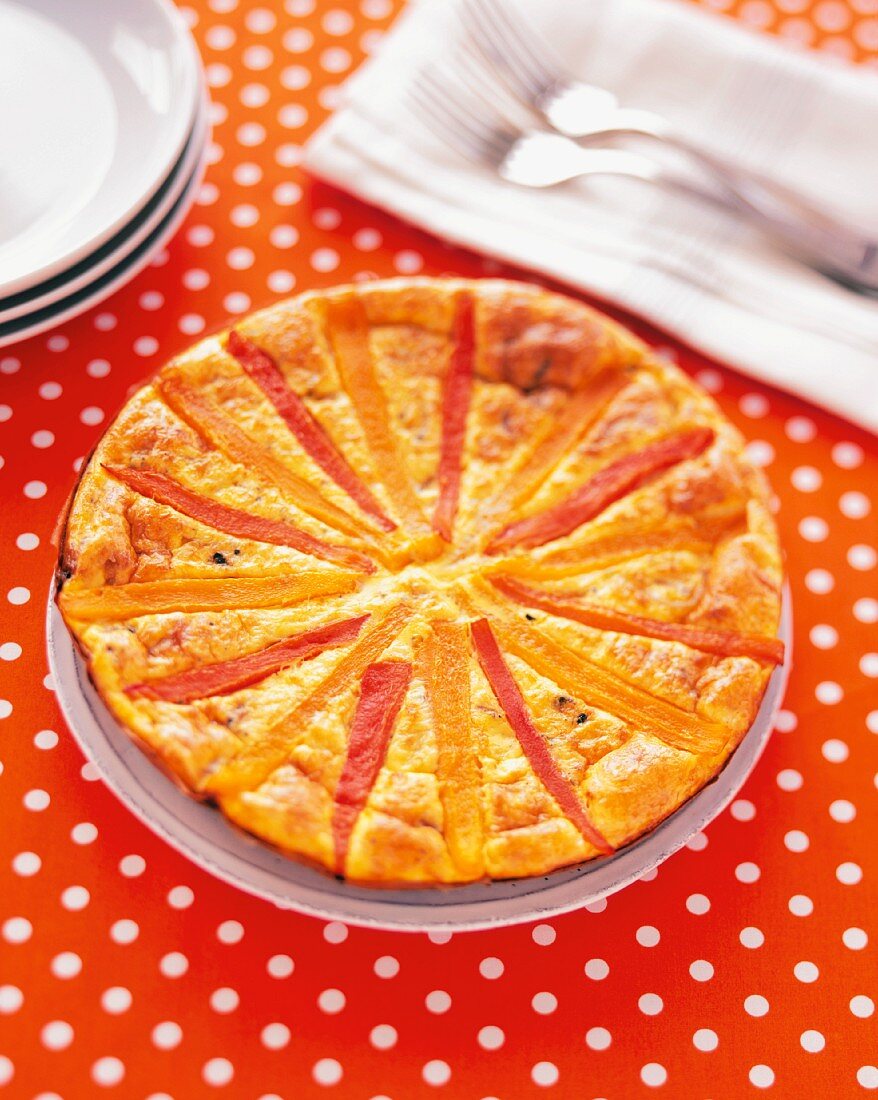 A Bell Pepper Frittata on an Orange Polka Dotted Tablecloth