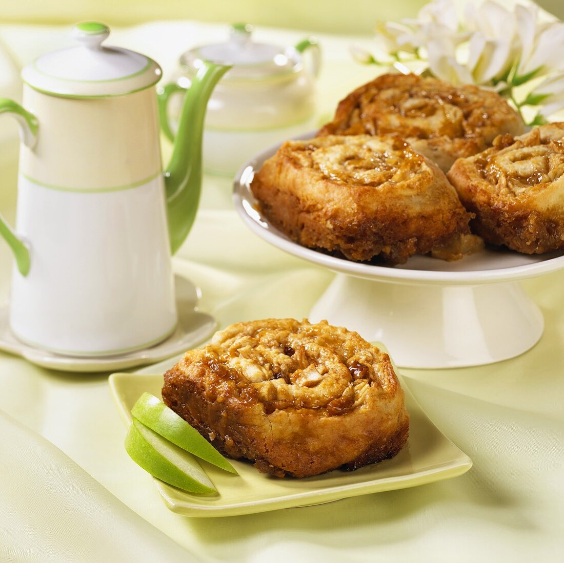 A Cinnamon Apple Roll with Walnuts on a Square Green Plate