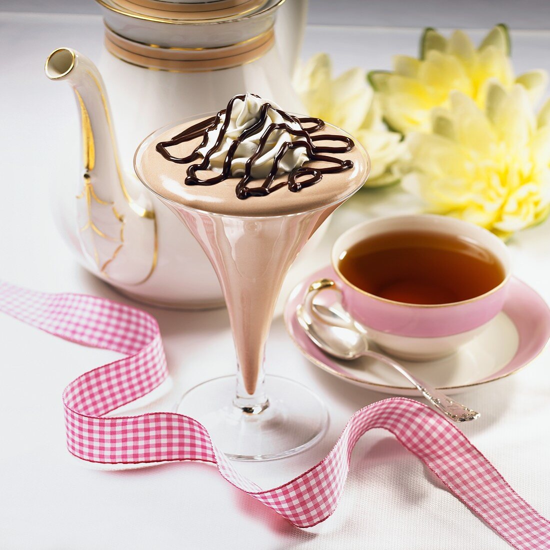 Chocolate Fudge Mousse in a Stem Glass with a Cup of Tea