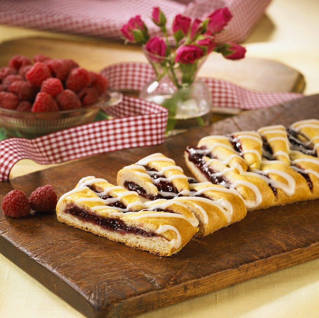 Partially Sliced Raspberry Strudel on a Wooden Board