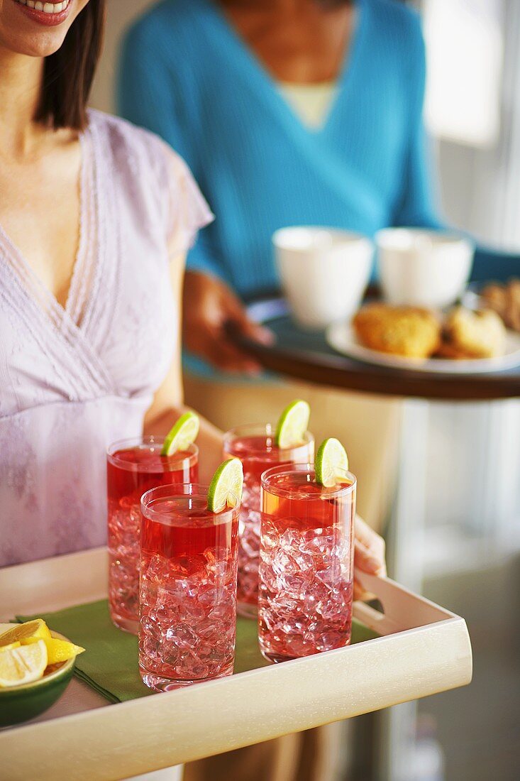 Young women serving snacks and drinks