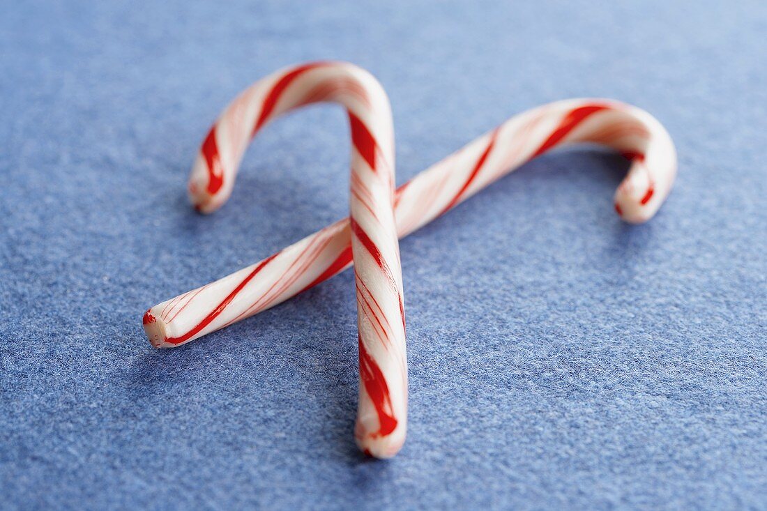 Two Candy Canes on a Blue Background