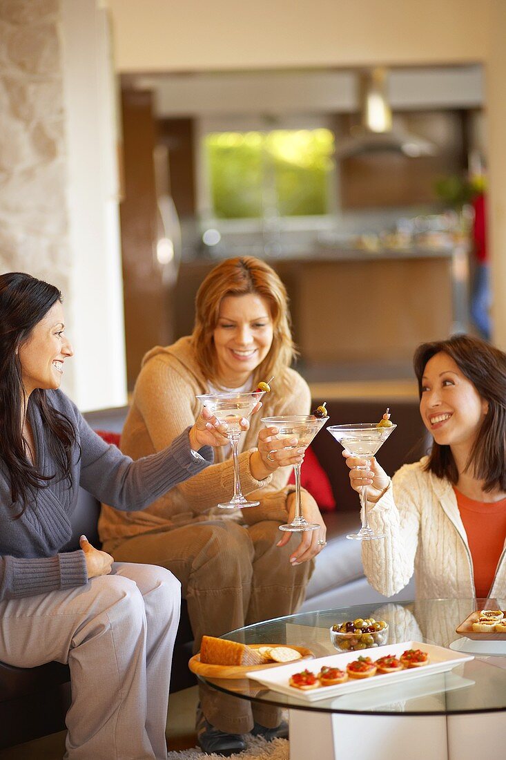 Three women raising glasses of Martini