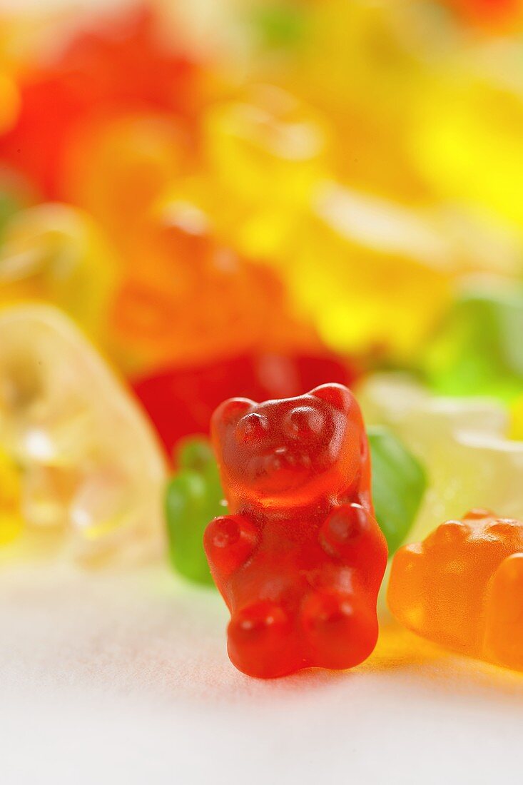 A Red Gummy Bear with Others Behind