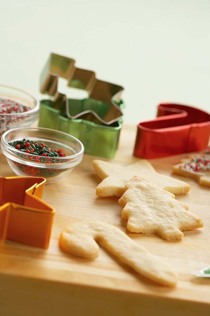 Baked Cookies, Cookie Cutters and Decorations on a Wooden Board